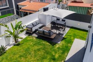 an aerial view of a patio with a table and chairs at Poolside oasis by Caparica beach in Charneca