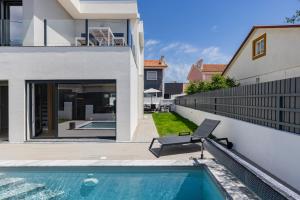 a swimming pool in the backyard of a house at Poolside oasis by Caparica beach in Charneca