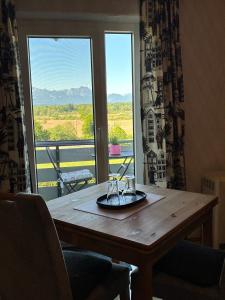 a wooden table with a plate on top of a window at Haus Chiemseeblick in Grabenstätt