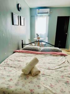 a bedroom with a bed with a teddy bear on it at ALCA Homestay in Palo