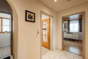 a hallway of a home with a door and a kitchen at Ferienwohnungen Lusenblick in Freyung +15 photos