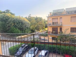 a balcony with cars parked next to a building at Iris Viola in Bagno a Ripoli