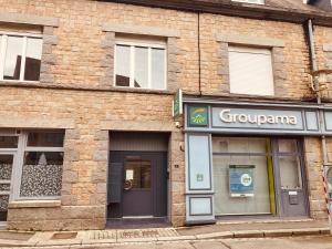 a brick building with a grouparma sign on it at Escapade au Mont St Michel in Pleine-Fougères