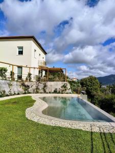 a swimming pool in the yard of a house at Casa dei Bruschi in Casarza Ligure