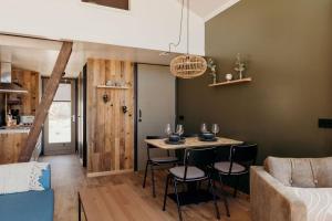 a living room with a table with chairs and a couch at Puur Petten in Petten