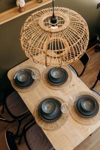 a wooden table with four plates on top of it at Puur Petten in Petten +14 photos