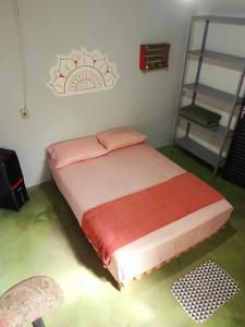 a bedroom with a bed with a red blanket at Casa da Pri em São Jorge in Sao Jorge