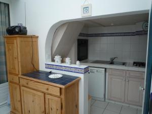 a small kitchen with a sink and a counter top at Suroit in L'Ile d'Yeu