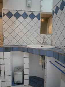 a bathroom with a sink and a mirror at Suroit in L'Ile d'Yeu