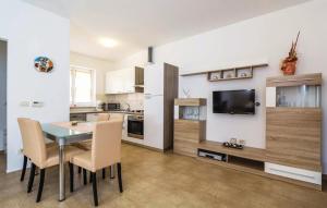 a kitchen and dining room with a table and chairs at Apartment Martina in Brseč