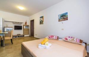 a hotel room with a bed and a dining room at Apartment Martina in Brseč