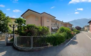 a building with a fence next to a street at 1Dest - Casa Bont in Riva del Garda