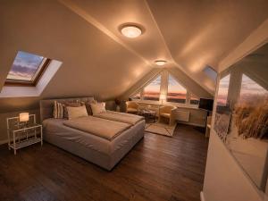 a bedroom with a bed in a room with large windows at Ferienhaus Am Achterwasser in Ueckeritz