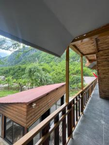 a balcony of a house with a view of a mountain at Shpia e Mikut Guesthouse in Theth