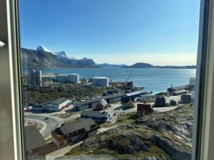 a view from a window of a town next to the water at Aurora Studio Apartments in Nuuk