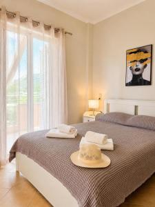 a bedroom with a bed with a hat on it at VALERIA Apartment in Vonitsa