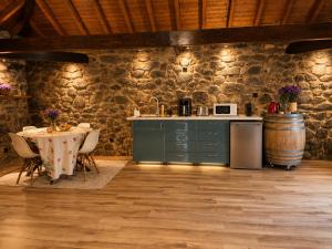 a kitchen and dining room with a table and a barrel at Open Space com Jacuzzi a 5 mn do centro de Lamego in Lamego