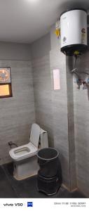 a bathroom with a toilet and a bucket at Shree radhe palace in Datia