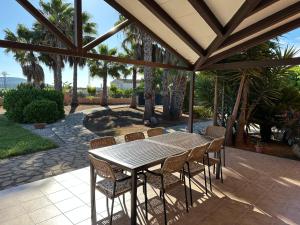 a wooden table and chairs on a patio at Casa en la naturaleza de Chella in Chella
