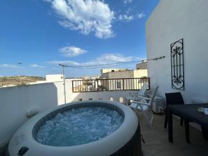 a hot tub on the roof of a balcony at Alina Boutique Living in Victoria