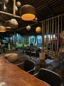 a restaurant with a table and chairs and lights at POUSADA PONTA DA ASA in Coruripe
