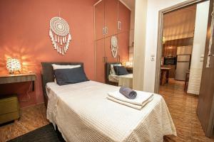 a bedroom with a bed with two towels on it at Mpoulakis Apt 46 in Kissamos +40 photos