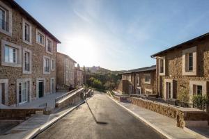 an empty street in an old town with buildings at Val D'Orcia Panoramic Suite in Montalcino