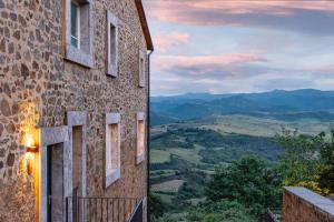 a building with windows and a view of the countryside at Val D'Orcia Panoramic Suite in Montalcino