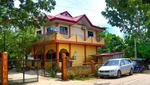 a house with a car parked in front of it at Villa Marquez in Camotes Islands +12 photos
