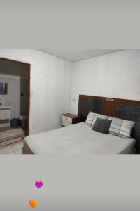 a bedroom with a bed with a heart on it at Hostel Pachamama in Presidente Prudente