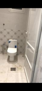 a bathroom with a white toilet in a room at شالية الفهد in As Sayl al Kabīr +6 photos