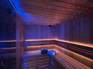 a sauna with purple lights and a blue bag in it at Förde Loge - Traumblick & Spa in Glücksburg