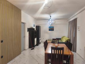 a living room with a table and a couch at Apartments Jakovljevic in Grebaštica +20 photos