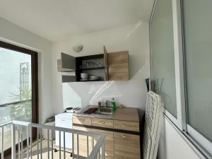 a small kitchen with a sink in a room at Alina Boutique Living in Victoria