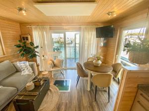 a living room with a couch and a table at Hausboot Yara am Steg 1D in Heiligenhafen