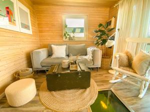 a living room with chairs and a table in a room at Hausboot Yara am Steg 1D in Heiligenhafen