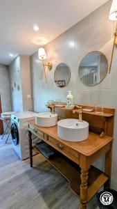 a bathroom with two sinks and a washing machine at Le Brocangîte à Jules - 4 pers in Bèze +20 photos