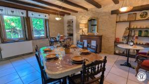 a dining room with a table and chairs in a kitchen at Le Brocangîte à Jules - 4 pers in Bèze