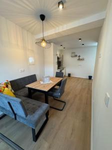 a living room with a table and a couch at Ferienwohnung Hofblick in Krustetten