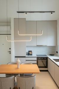 a kitchen with a wooden table and chairs at Kleopatra Homes - Napoleontos in Messini