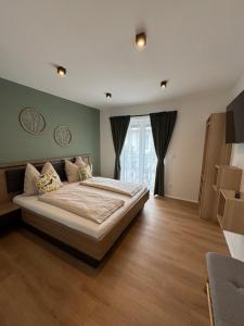 a bedroom with a large bed and a window at Ferienwohnung Hofblick in Krustetten