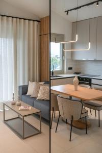 a kitchen and living room with a table and a couch at Kleopatra Homes - Napoleontos in Messini