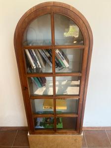 a wooden book shelf with books in it at Artillery Barracks Accommodation in Terezín