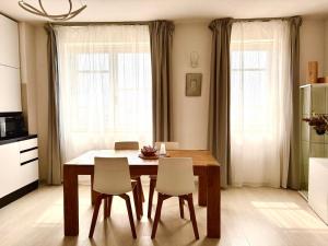 a dining room table and chairs in a kitchen at Val D'Orcia Panoramic Suite in Montalcino