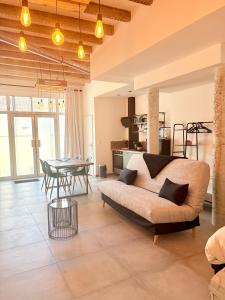 a living room with a couch and a table at Loft avec terrasse au pied du château in Amboise