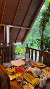 a wooden table with many different types of food on it at Oak Haven Cabana Sigiriya in Sigiriya +74 photos
