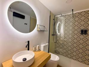 a bathroom with a toilet and a sink and a mirror at YourHouse O Canelar in Allariz +17 photos