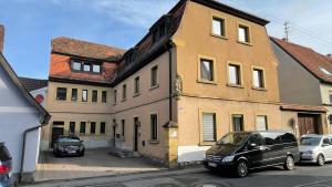 a house with two cars parked in front of it at Max Haus 2 in Karlstadt