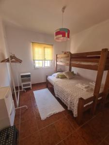 a bedroom with two bunk beds and a window at Dunas Rest in Odemira