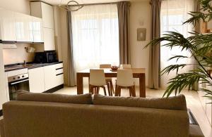 a living room with a couch and a table with chairs at Val D'Orcia Panoramic Suite in Montalcino